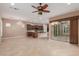 A spacious living area featuring tile floors, ceiling fan and dark wood cabinets at 1260 E Sweet Citrus Dr, Queen Creek, AZ 85140