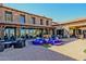 Elegant patio with a vibrant blue fountain and brickwork, complemented by stylish outdoor furniture at 1260 E Sweet Citrus Dr, Queen Creek, AZ 85140