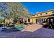 Elegant outdoor patio featuring a tile fountain, brick pavers, and comfortable seating areas at 1260 E Sweet Citrus Dr, Queen Creek, AZ 85140
