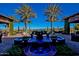 Outdoor patio showcasing a cobalt fountain with seating areas and lush landscaping with golf course views at 1260 E Sweet Citrus Dr, Queen Creek, AZ 85140