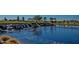 Picturesque pond featuring cascading waterfalls, lush greenery, and a serene golf course backdrop at 1260 E Sweet Citrus Dr, Queen Creek, AZ 85140