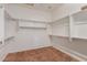 Spacious walk-in closet features custom shelving and ample storage space for organizing wardrobe at 1260 E Sweet Citrus Dr, Queen Creek, AZ 85140