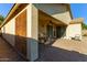 Covered patio with stylish privacy wall and brick pavers at 1277 W Stephanie Ln, San Tan Valley, AZ 85143