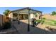 Backyard with pavers, grass, and grill area perfect for entertaining at 1277 W Stephanie Ln, San Tan Valley, AZ 85143