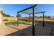 Backyard with pavers, grass, and grill area perfect for entertaining at 1277 W Stephanie Ln, San Tan Valley, AZ 85143