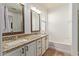 Spacious bathroom featuring dual sinks, granite counters, and tile flooring with tub in view at 1277 W Stephanie Ln, San Tan Valley, AZ 85143