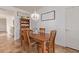 Cozy dining area with a wooden table, four chairs, stylish decor, and tiled flooring at 1277 W Stephanie Ln, San Tan Valley, AZ 85143
