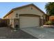 Close up of the home's exterior including a two-car garage and drought resistant landscaping at 1277 W Stephanie Ln, San Tan Valley, AZ 85143