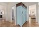 Hallway features a stylish blue cabinet with baskets on top for added storage at 1277 W Stephanie Ln, San Tan Valley, AZ 85143