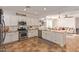 Modern kitchen with stainless appliances, granite counters, tile flooring, and an open layout flowing to the living area at 1277 W Stephanie Ln, San Tan Valley, AZ 85143