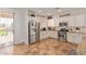 Bright, modern kitchen with stainless steel appliances, white cabinets, granite countertops, and tile flooring at 1277 W Stephanie Ln, San Tan Valley, AZ 85143