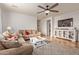 Cozy living room featuring tile floors, a ceiling fan, comfortable seating, and a seamless view of the entertainment center at 1277 W Stephanie Ln, San Tan Valley, AZ 85143