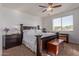 Relaxing main bedroom featuring a dark wood bed frame, lamps, and neutral tones at 1277 W Stephanie Ln, San Tan Valley, AZ 85143
