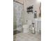 Full bathroom with a shower featuring a curtain and a decorative mirror over a pedestal sink at 12934 W Chapala Dr, Sun City West, AZ 85375