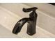 Close-up of a bronze bathroom faucet, adding a touch of elegance to the vanity at 12934 W Chapala Dr, Sun City West, AZ 85375