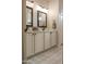 Bathroom featuring a double sink vanity and patterned tile flooring at 12934 W Chapala Dr, Sun City West, AZ 85375