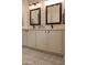 Bathroom featuring a double sink vanity and patterned tile flooring at 12934 W Chapala Dr, Sun City West, AZ 85375