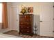 Cozy bedroom features a dark wood dresser with decor, next to two white doors at 12934 W Chapala Dr, Sun City West, AZ 85375