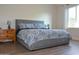 Bedroom featuring a grey platform bed with a blue and white patterned comforter set at 12934 W Chapala Dr, Sun City West, AZ 85375