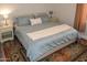 Cozy bedroom features a bed with an accent rug and bedside tables with lamps at 12934 W Chapala Dr, Sun City West, AZ 85375