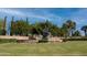 Community water fountain feature surrounded by mature trees and lawn at 12934 W Chapala Dr, Sun City West, AZ 85375