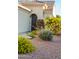 Beautiful home showcasing the entrance with colorful flowering plants and lush green landscaping at 12934 W Chapala Dr, Sun City West, AZ 85375