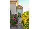 Close up of front entrance with colorful plants surrounding the house at 12934 W Chapala Dr, Sun City West, AZ 85375