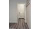 Hallway leading to garage access and a shiplap accent wall with hooks for storage at 12934 W Chapala Dr, Sun City West, AZ 85375
