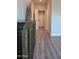 Hallway featuring decorative furniture, light gray walls, white trim and luxury vinyl flooring at 12934 W Chapala Dr, Sun City West, AZ 85375