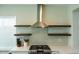 Modern kitchen featuring stainless steel appliances and floating shelves at 12934 W Chapala Dr, Sun City West, AZ 85375