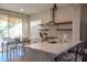 Bright kitchen with quartz countertops, stainless appliances, floating shelves, and an adjacent dining area at 12934 W Chapala Dr, Sun City West, AZ 85375