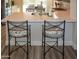 Kitchen island with quartz countertops, seating, and stylish fixtures at 12934 W Chapala Dr, Sun City West, AZ 85375