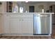 Kitchen area showcases white cabinets, quartz countertops, stainless steel dishwasher, and luxury vinyl flooring at 12934 W Chapala Dr, Sun City West, AZ 85375