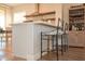Modern kitchen island with quartz countertops, seating, and sleek stainless steel appliances at 12934 W Chapala Dr, Sun City West, AZ 85375