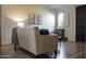 Comfortable living room with neutral furniture, wood-look flooring, and stylish decor at 12934 W Chapala Dr, Sun City West, AZ 85375