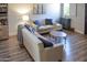 Comfortable living room with neutral furniture, wood-look flooring, and stylish decor at 12934 W Chapala Dr, Sun City West, AZ 85375