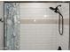 Modern shower with tiled walls, rain style shower head, and blue patterned curtain at 12934 W Chapala Dr, Sun City West, AZ 85375