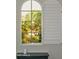 Window with shutters displaying a view of a beautiful garden at 12934 W Chapala Dr, Sun City West, AZ 85375