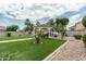 Backyard view with artificial turf, desert landscaping and a charming gazebo for outdoor gatherings at 14318 N 142Nd Ln, Surprise, AZ 85379