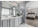 Bathroom with double vanity, tile floors, and access to the attached bedroom at 14318 N 142Nd Ln, Surprise, AZ 85379