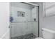 Modern bathroom showcasing a sleek glass shower, tiled walls, and upscale fixtures for a luxurious experience at 14318 N 142Nd Ln, Surprise, AZ 85379