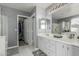 Bathroom with double vanity, walk-in closet, marble floors, and built-in shower at 14318 N 142Nd Ln, Surprise, AZ 85379