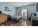 Stylish bedroom with hardwood floors and a comfortable bed, enhanced by natural light from the window at 14318 N 142Nd Ln, Surprise, AZ 85379