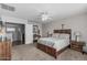 Relaxing bedroom with comfortable queen bed, ceiling fan, and hardwood floor entry at 14318 N 142Nd Ln, Surprise, AZ 85379