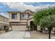 Charming two-story home featuring a well-manicured lawn, a two-car garage, and a welcoming entryway at 14318 N 142Nd Ln, Surprise, AZ 85379