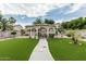 Relaxing backyard gazebo with lush green lawn, desert landscaping and a welcoming outdoor retreat at 14318 N 142Nd Ln, Surprise, AZ 85379