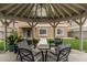 Backyard gazebo with comfortable seating and a view of the landscaped lawn and house at 14318 N 142Nd Ln, Surprise, AZ 85379