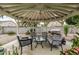 Covered outdoor gazebo featuring comfortable seating, table, and outdoor grill for backyard entertaining at 14318 N 142Nd Ln, Surprise, AZ 85379