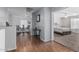 Hallway view showcasing hardwood floors, neutral paint, and entries to bedroom and living spaces at 14318 N 142Nd Ln, Surprise, AZ 85379