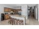 Well-lit kitchen features wooden cabinets, a large island with bar seating, and stainless steel appliances at 14318 N 142Nd Ln, Surprise, AZ 85379